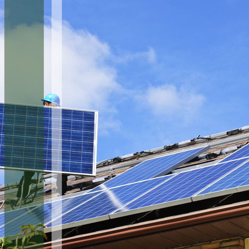 Solar contractor carrying a solar panel on a roof