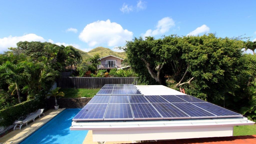 Solar panels on a house by a pool