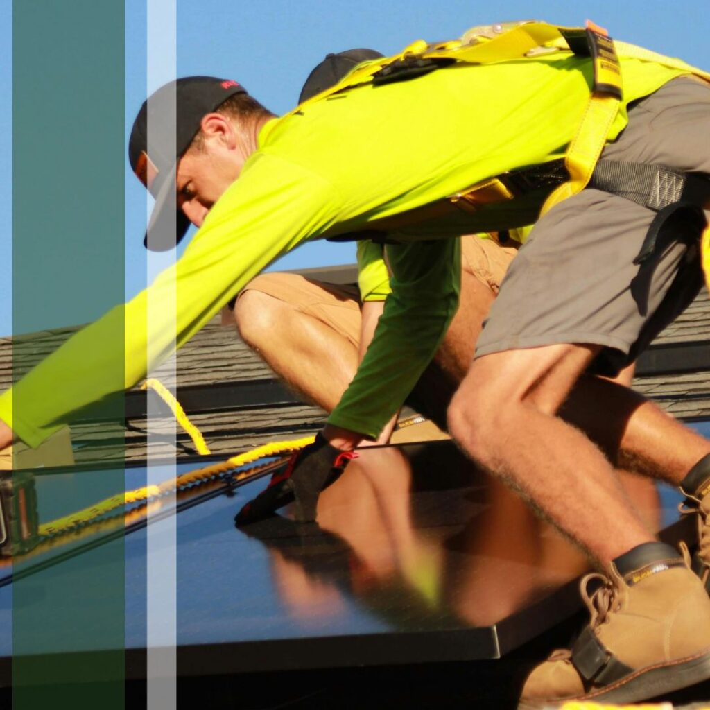 Solar panels being installed by two people